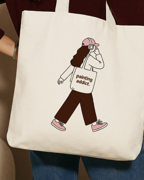 Beige tote bag with a girl illustration and the text Painting Addict