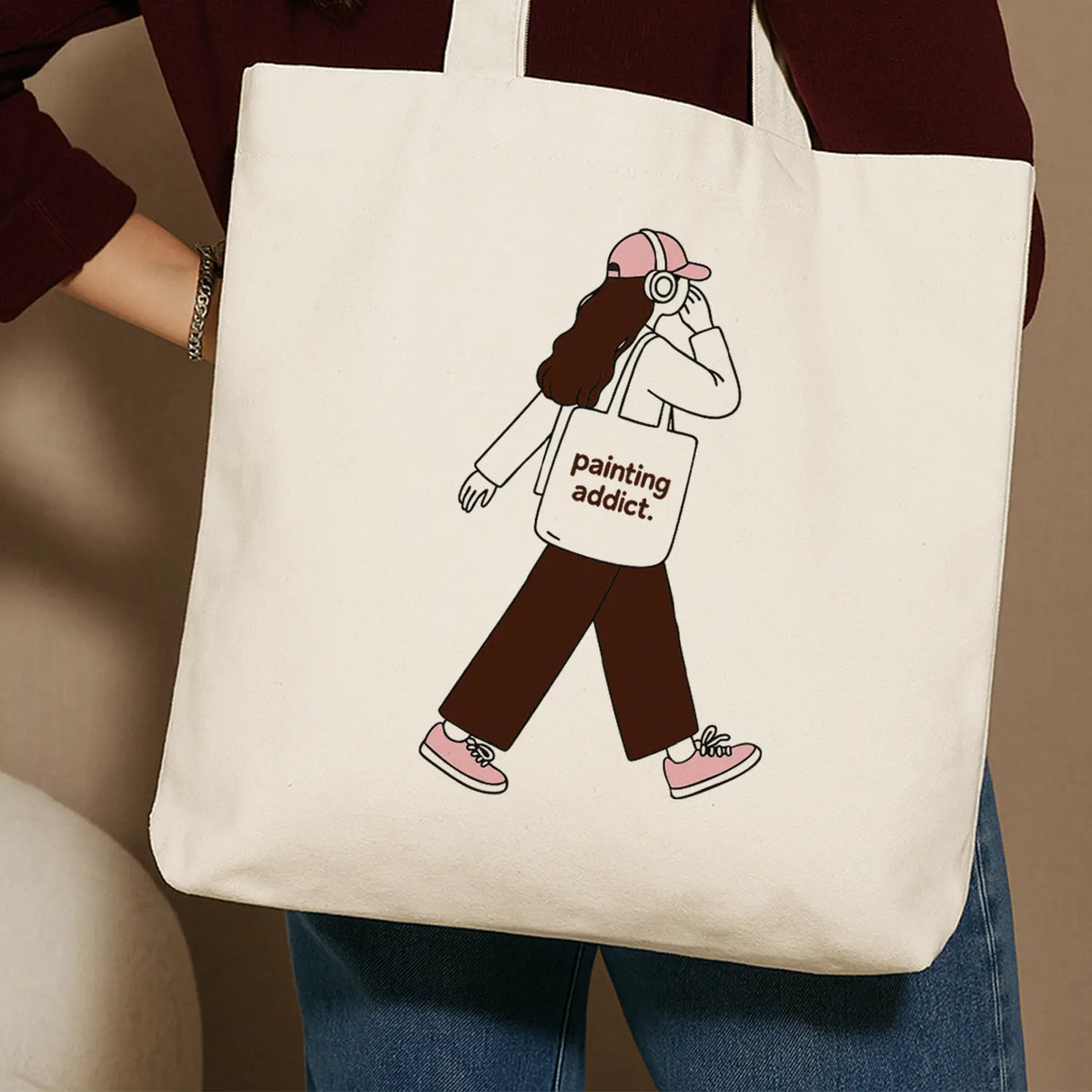 Beige tote bag with a girl illustration and the text Painting Addict