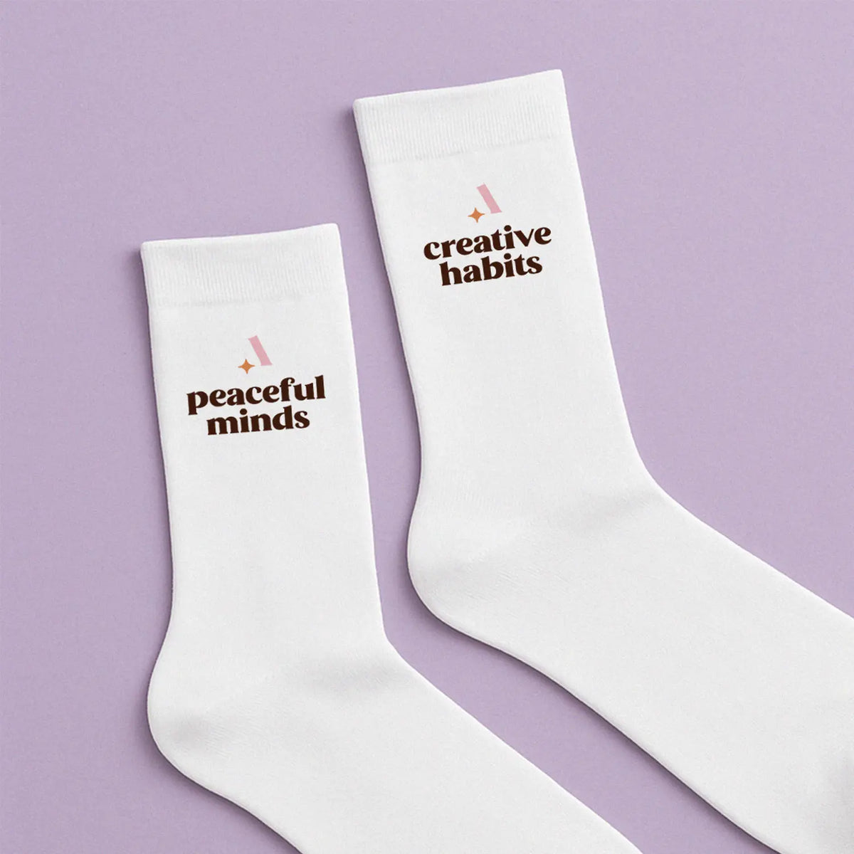 White socks with the text Peaceful Minds and Creative Habits
