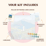 Flatlay of the Quiet Fields paint by numbers kit with canvas, paints, brushes, and reference materials
