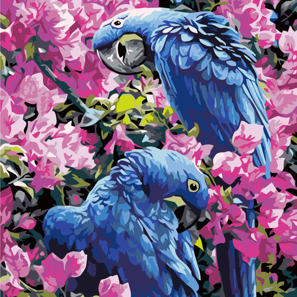 Two vibrant blue parrots perched among lush pink blossoms