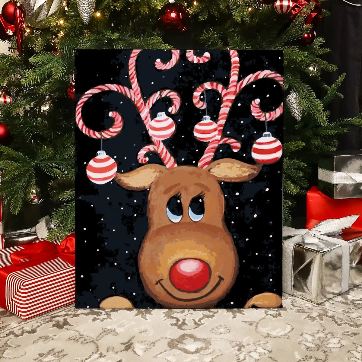 Completed Christmas Dear paint by numbers artwork showing a reindeer with candy cane antlers and ornaments on a snowy background.