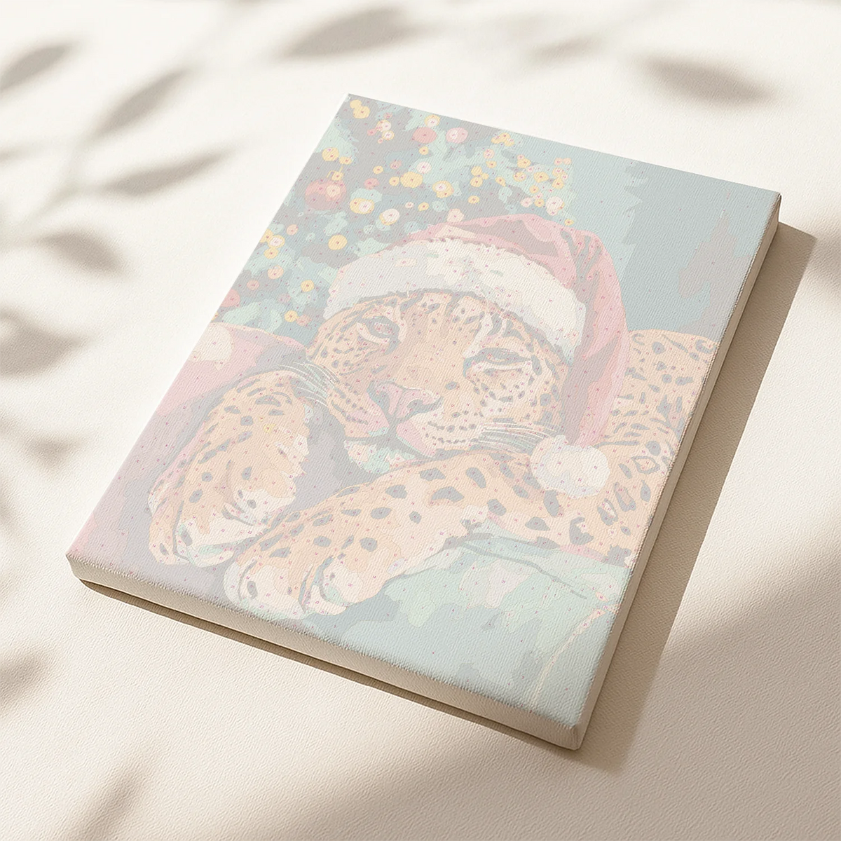 Christmas Paws paint by numbers canvas showing a leopard wearing a Santa hat under a Christmas tree.