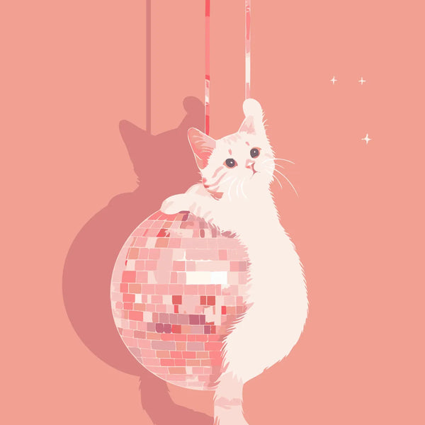 White cat playfully hanging onto a pink disco ball