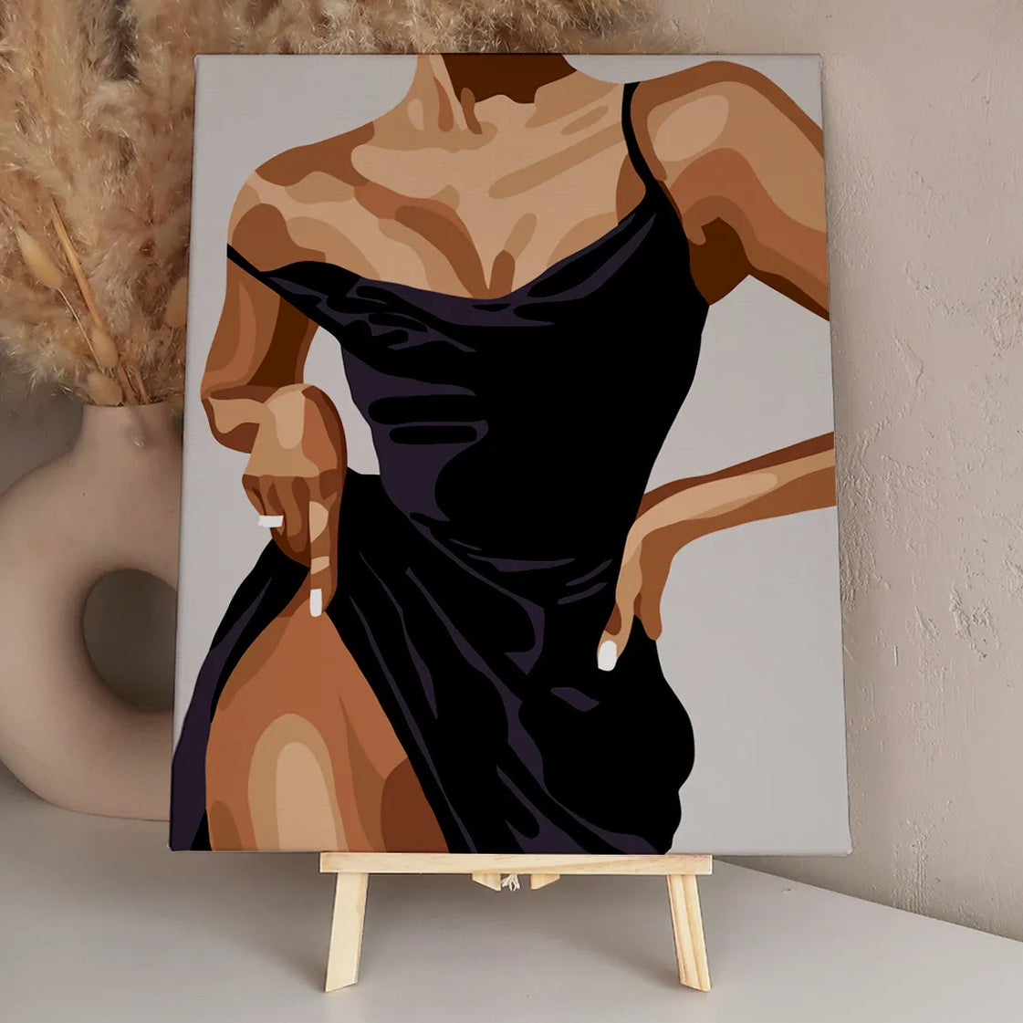 Elegant woman in a black dress striking a confident pose