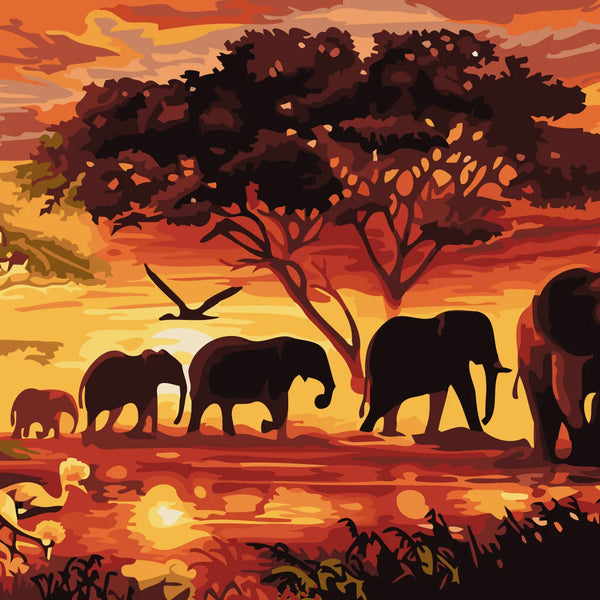 Elephants walking through an African savanna at sunset