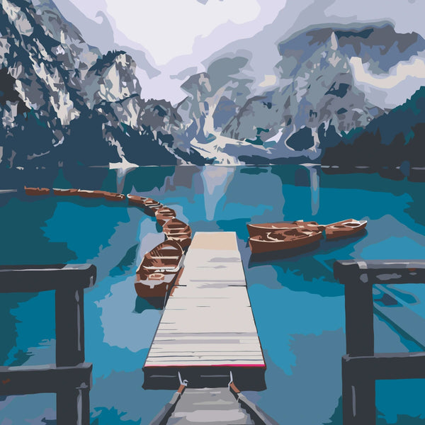Scenic mountain lake with wooden dock and boats in calm water