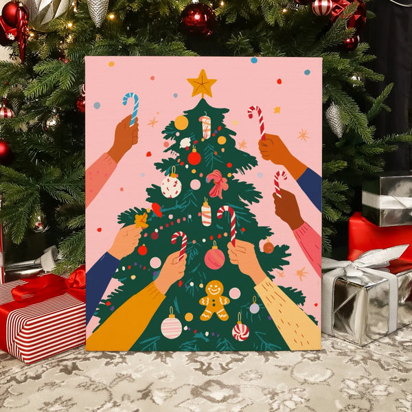 Completed Festive Tree paint by numbers artwork showing hands decorating a Christmas tree with candy canes and ornaments.