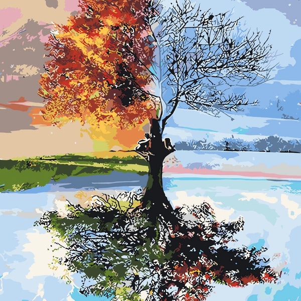 A tree depicting both summer and winter with a reflective lake