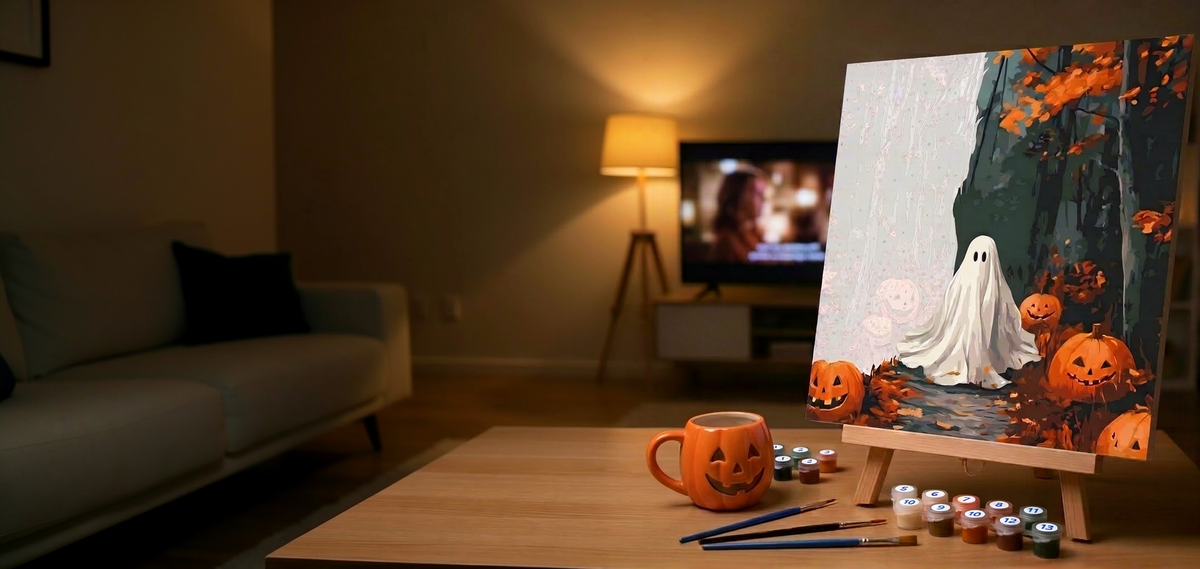 A part painted Halloween paint by numbers canvas on an easel with numbered paint pots and brushes