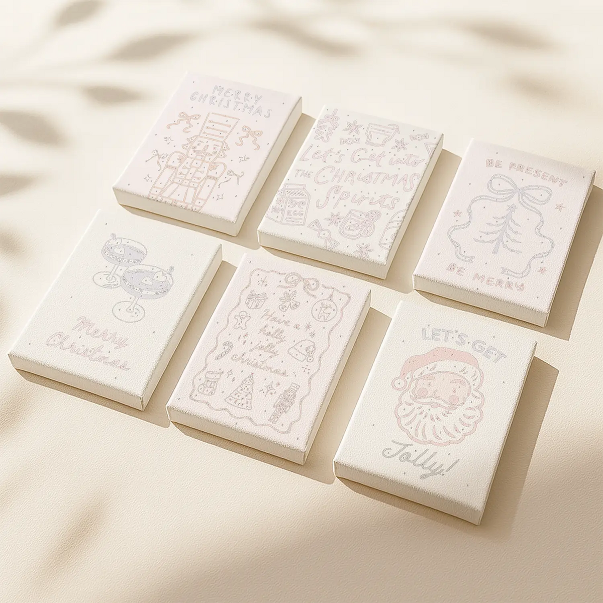 Holiday Doodle paint by numbers mini canvas set of 6 by Artspark showing outlined festive illustrations ready to paint, including Santa, cocktails, and Christmas decor.