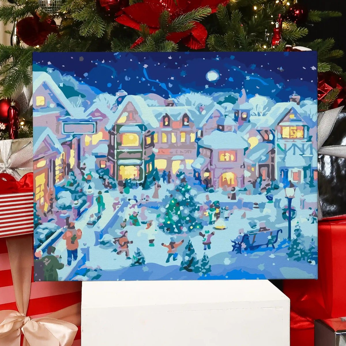 Completed Ice Skating paint by numbers artwork showing a Christmas village with people skating and glowing lights.