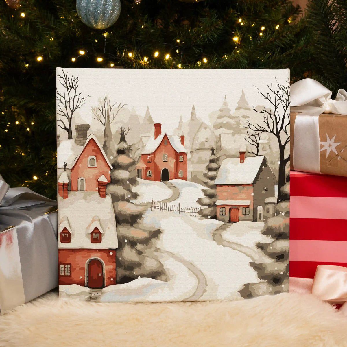 Completed It’s Snowing paint by numbers artwork showing a peaceful snow-covered village with warm glowing homes.