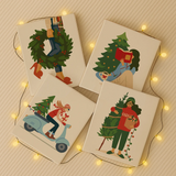 Completed Merry Mood paint by numbers canvases by Artspark showing warm modern Christmas art — decorating the tree, gift delivery, reading by lights, and festive wreaths.
