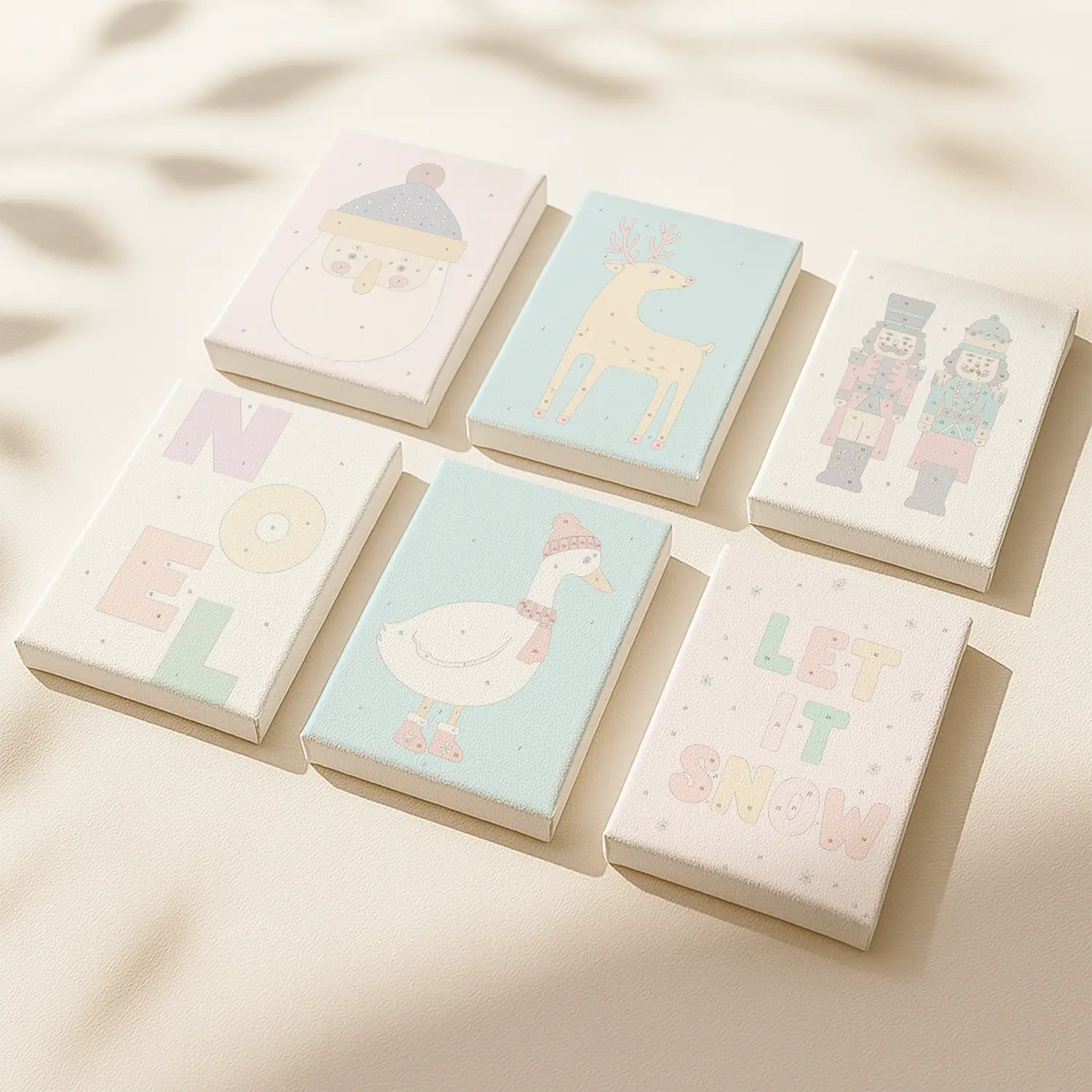 Merry Time paint by numbers set of 6 pastel mini canvases by Artspark featuring minimalist Christmas designs like Santa, reindeer, goose, and nutcrackers ready to paint — modern DIY holiday decor.