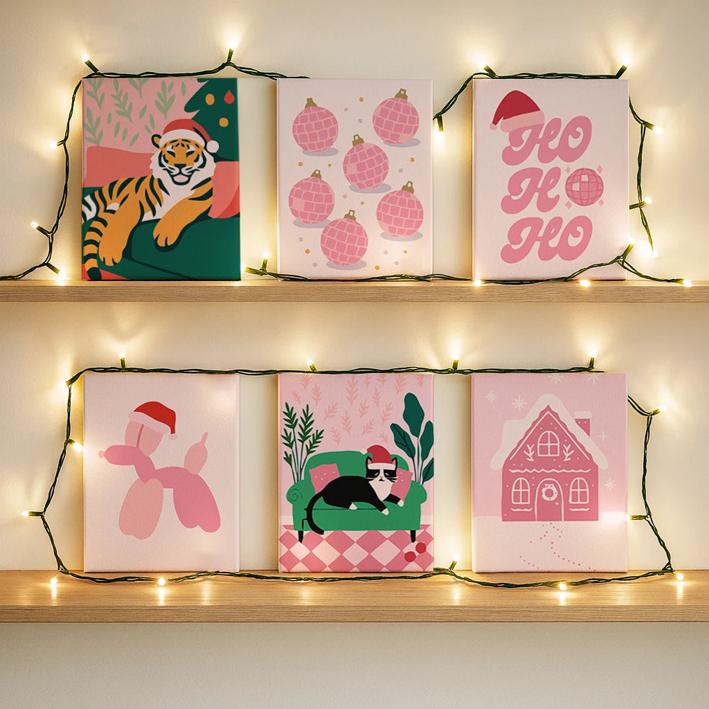 Completed Retro Noel paint by numbers canvases by Artspark showing vibrant pop-style Christmas designs — playful tiger, balloon dog, ornaments, and cozy holiday scenes.