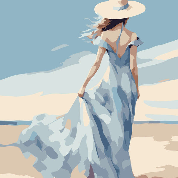 Woman in flowing blue dress and hat walking on the beach