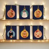 Completed Sweet Gifts paint by numbers mini canvases by Artspark featuring festive animal designs in Christmas ornaments with deep blue backgrounds.
