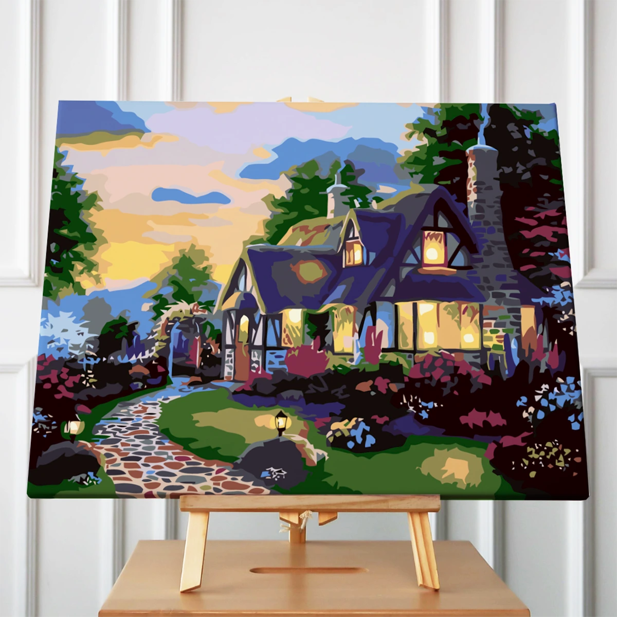 Stylized painting of a cozy cottage with glowing lights at sunset