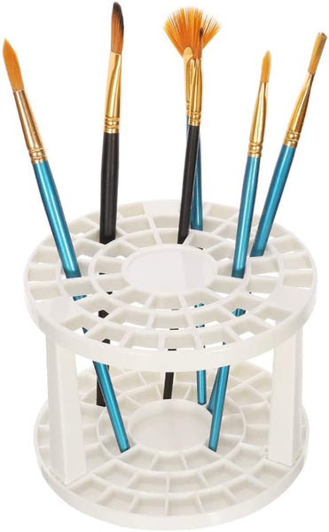White paint brush holder stand with multiple brushes – ideal for drying and organizing art tools in a creative workspace