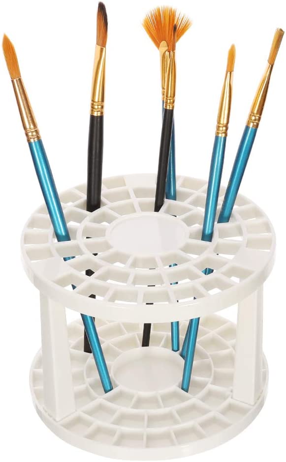 White paint brush holder stand with multiple brushes – ideal for drying and organizing art tools in a creative workspace