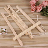Folded pine wood easel on a wooden surface – compact storage